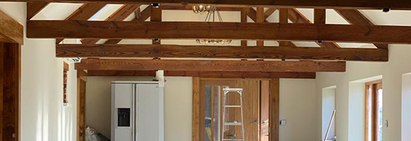 an interior with wooden beams on the ceiling with the walls painted white
